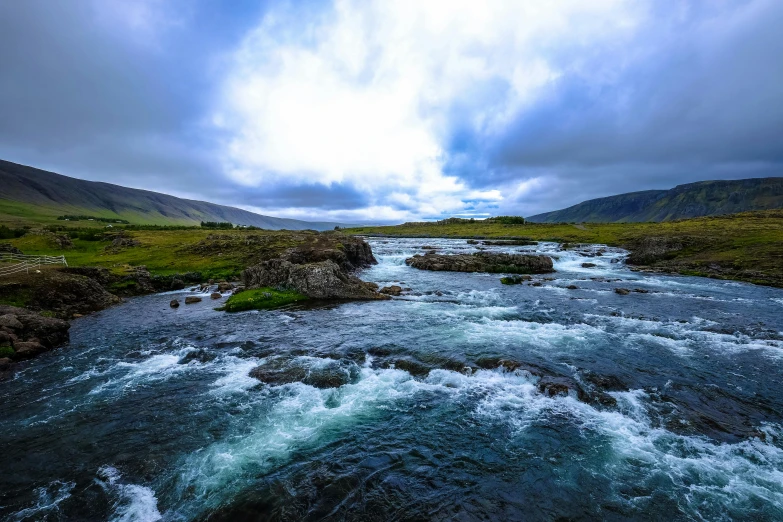 a river running through a lush green valley, by Hallsteinn Sigurðsson, pexels contest winner, hurufiyya, white water rapids, thumbnail, dramatic sky, 2 0 0 0's photo