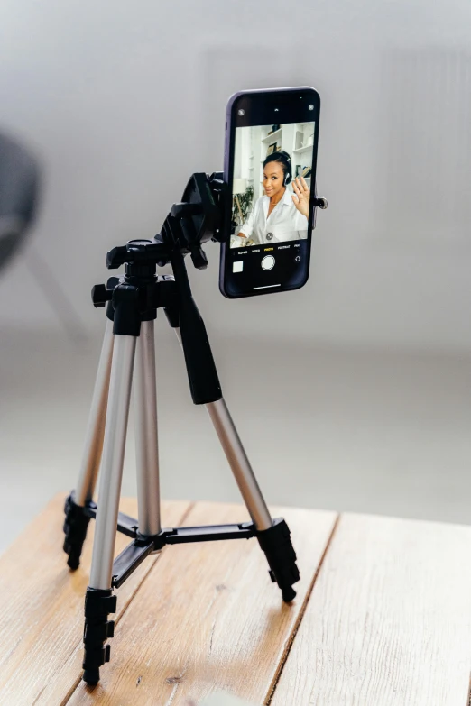 a cell phone sitting on top of a tripod, a picture, trending on pexels, video art, home photography portrait, medical photography, modeling, indoor picture