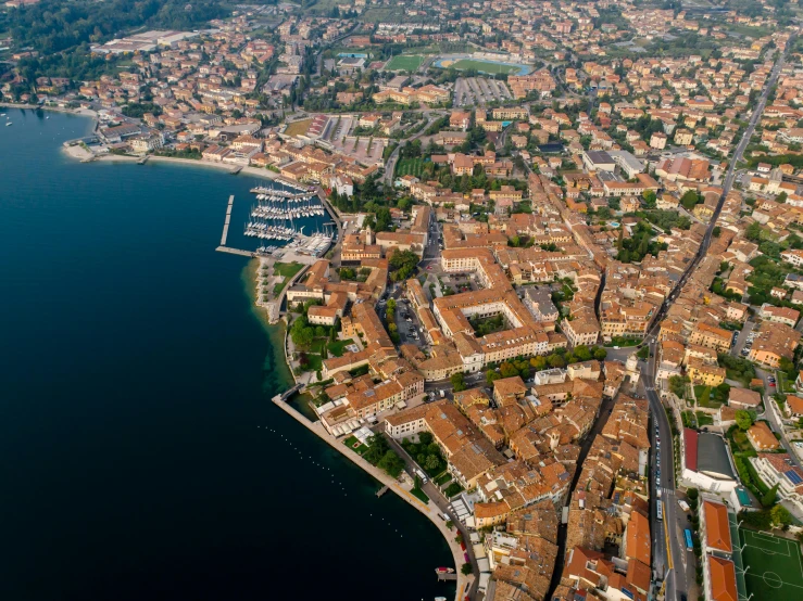 an aerial view of a city next to a body of water, by Patrick Pietropoli, pexels contest winner, hyperrealism, square, preserved historical, sistina, 8k high quality and resolution