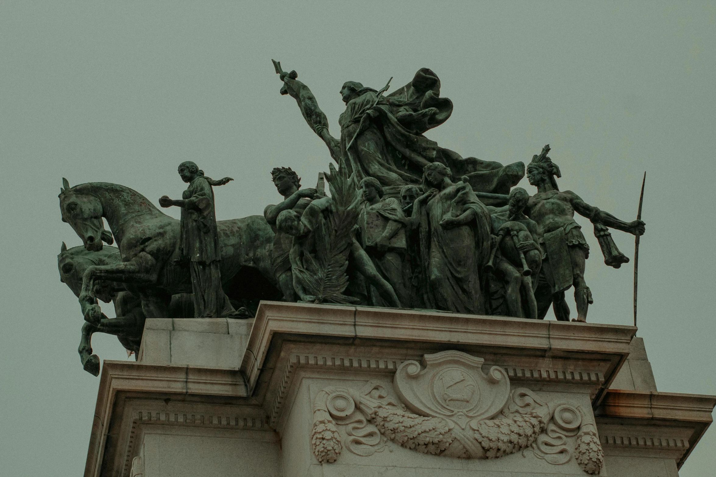 a statue that is on top of a building, by Attila Meszlenyi, pexels contest winner, neoclassicism, cavalry, kara walker, square, a group of people