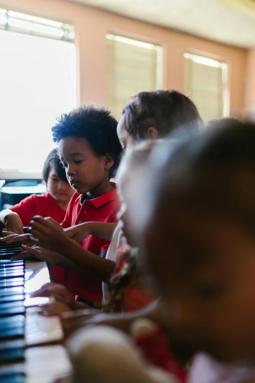 a group of children sitting at a table playing a piano, pexels contest winner, american barbizon school, varying ethnicities, screensaver, panoramic shot, shot on sony a 7 iii