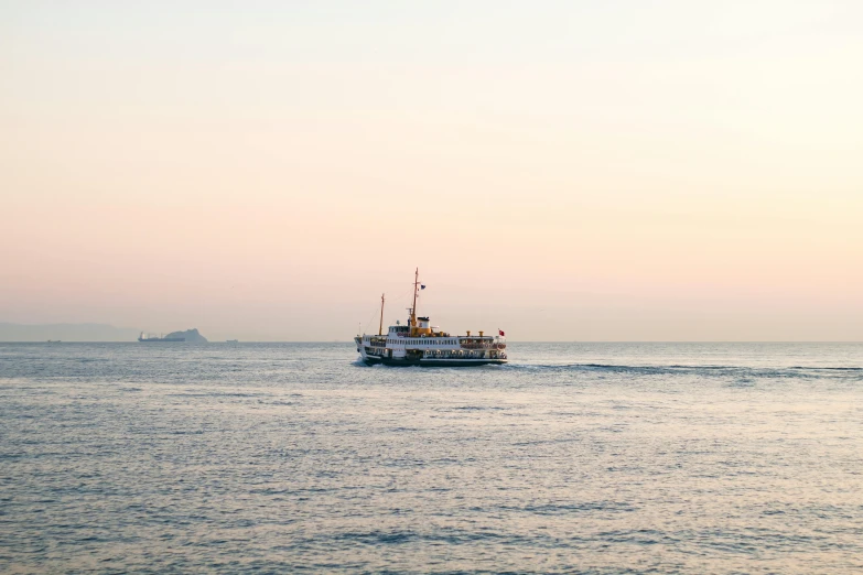 a boat traveling across a large body of water, a picture, unsplash, romanticism, japan shonan enoshima, soft warm light, sea queen, mid shot photo