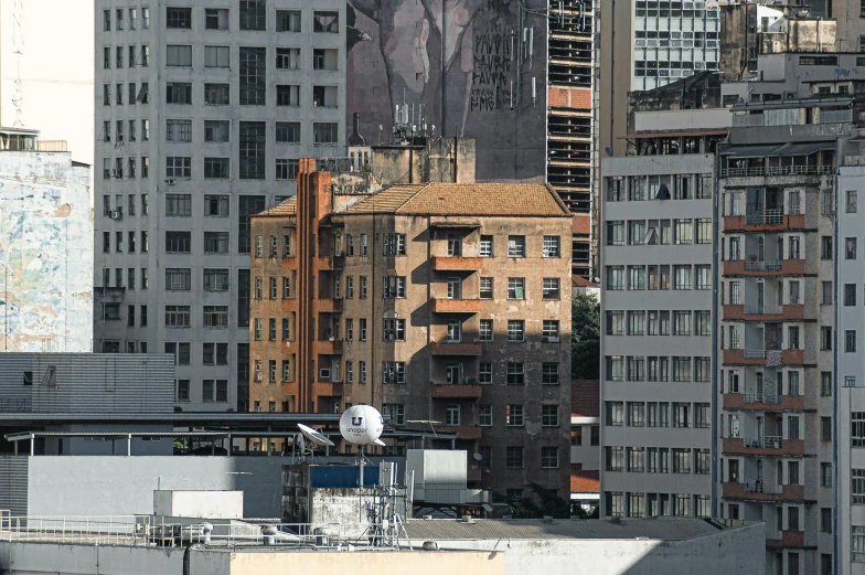 a bird that is sitting on top of a building, inspired by Thomas Struth, unsplash, photorealism, in chippendale sydney, seen from a distance, gigapixel photo, rundown buildings