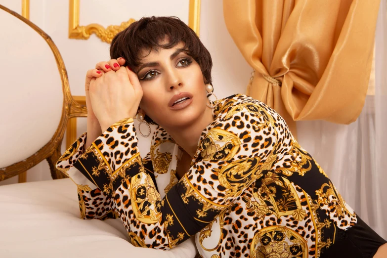 a woman laying on a bed in a leopard print shirt, baroque, greek ameera al taweel, promotional image, thumbnail, ornate with gold trimmings