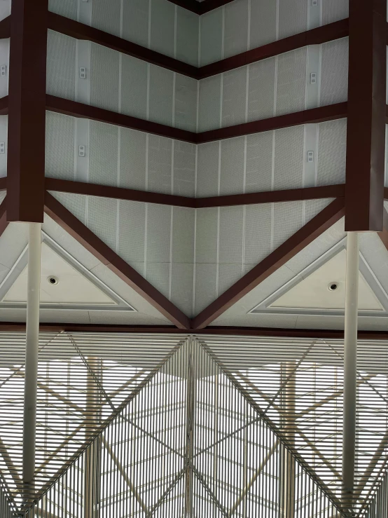 a clock that is on the side of a building, looking at the ceiling, canopy, slanted ceiling, heavy lines