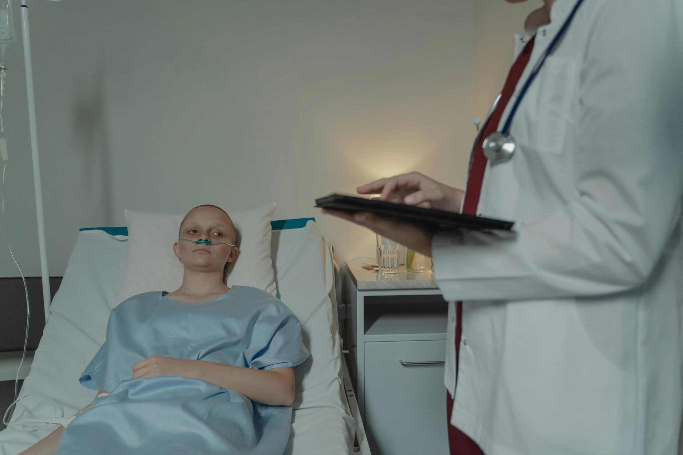 a woman laying in a hospital bed with a stethoscope, a colorized photo, by Attila Meszlenyi, pexels contest winner, still from a live action movie, with a white complexion, brain surgery, shot on sony a 7 iii