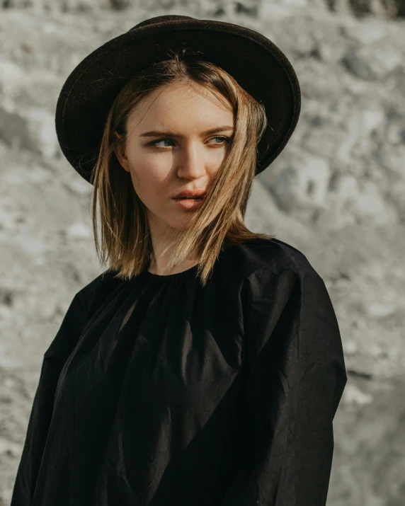 a woman wearing a black top and a hat, pexels contest winner, non binary model, black and brown, young blonde woman, no watermarks