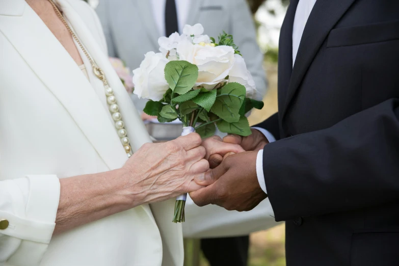 a close up of a person holding a flower, wedding, across holding a hand, peter guthrie, multiple stories