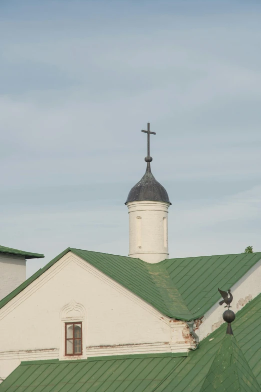 a white church with a green roof and a steeple, inspired by Illarion Pryanishnikov, renaissance, zoomed, closeup!!!!!!, rooftop, ox