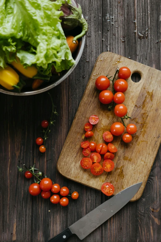 a wooden cutting board topped with tomatoes next to a bowl of lettuce, pexels contest winner, renaissance, bittersweet, subtle details, transformation, “berries