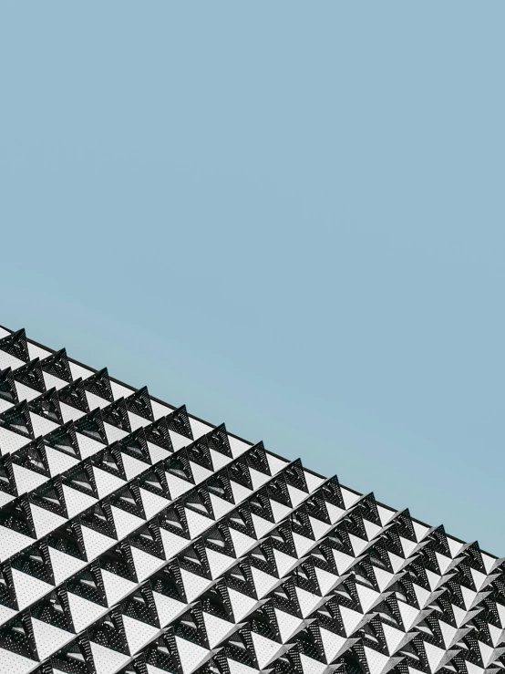 a black and white building with a blue sky in the background, unsplash contest winner, brutalism, intricate triangular designs, gradient and patterns wallpaper, ilustration, stacked image