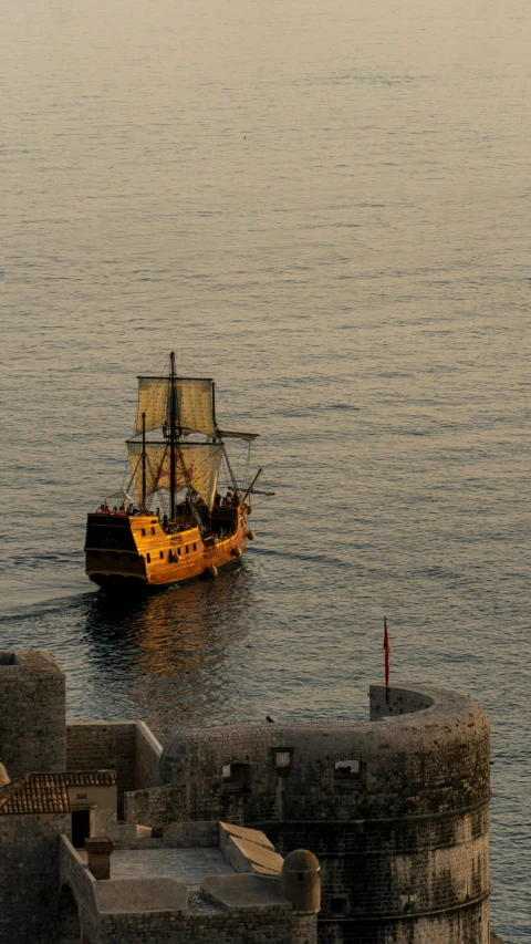 a boat floating on top of a body of water, pexels contest winner, renaissance, gold galleon ship, black. yellow, dubrovnik, summer evening