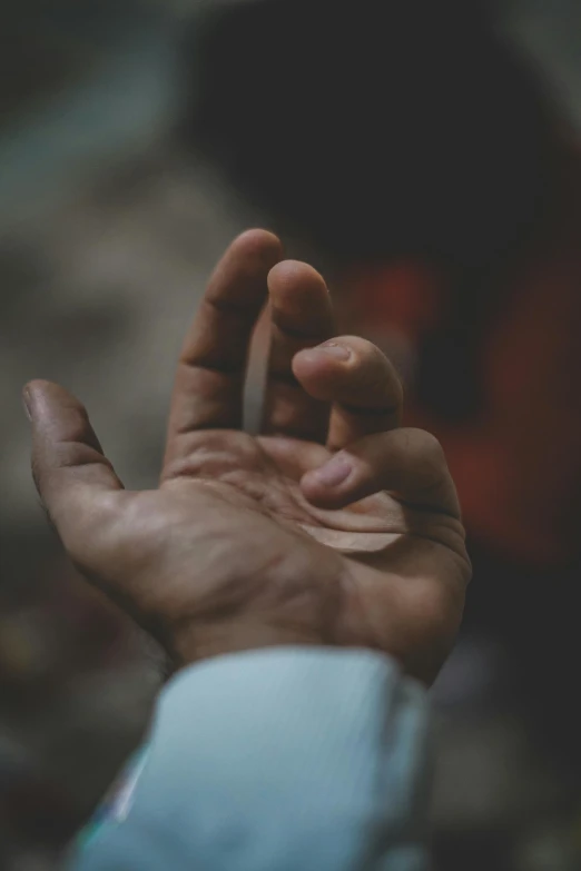 a close up of a person's hand holding something, unsplash, paul barson, diverse, begging, carefully crafted