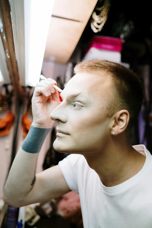 a man that is standing in front of a mirror, an album cover, inspired by Mikhail Lebedev, in professional makeup, transgender, andrzej duda, face fully visible