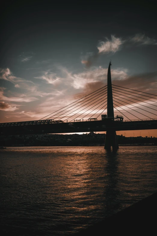 a bridge over a body of water at sunset, an album cover, by Adam Szentpétery, pexels contest winner, modernism, glasgow, the photo was taken from a boat, today\'s featured photograph 4k, portrait of tall