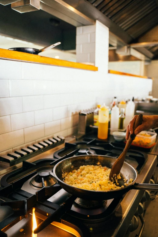a person cooking food on a stove in a kitchen, by Carey Morris, mac and cheese, gourmet restaurant, kitchen counter, performance