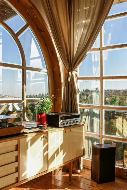 a kitchen with a stove top oven sitting next to a window, by Julia Pishtar, renaissance, amazing view, sunshafts, located in hajibektash complex, glass domes