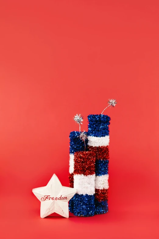 two red, white and blue fireworks sticks and a star on a red background, a portrait, by Julia Pishtar, stacked image, miniature product photo, can, crispy