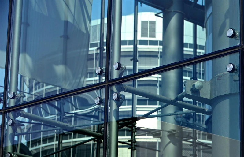 a clock that is on the side of a building, mirror and glass surfaces, canopies, thumbnail, steel window mullions