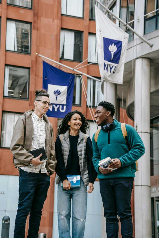 a group of people standing in front of a building, in new york city, at college, blue and gray colors, promotional image