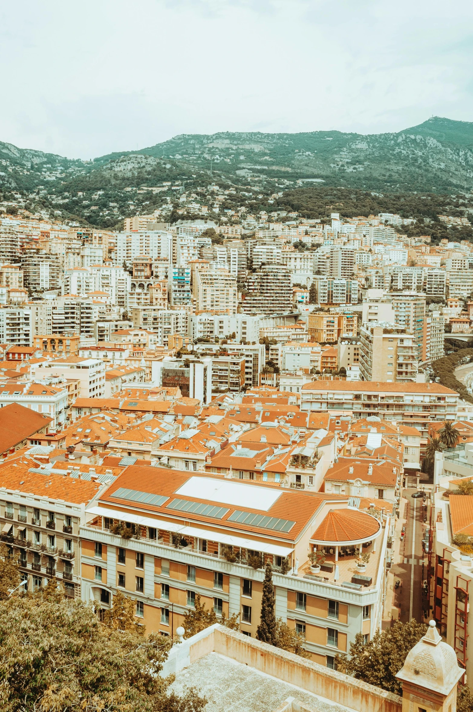 a view of a city from the top of a hill, a colorized photo, pexels contest winner, renaissance, monaco, square, brown, drone footage