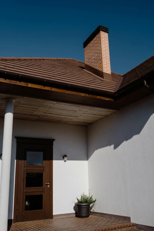 a white house with a potted plant on the front porch, an album cover, inspired by Gyula Aggházy, unsplash, renaissance, brown:-2, chimney, panorama view, galvalume metal roofing