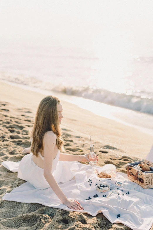 a couple having a picnic on the beach, inspired by Oleg Oprisco, unsplash, a beautiful woman in white, fine dining, profile image, champagne commercial