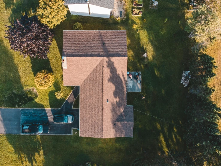 a house sitting on top of a lush green field, pexels contest winner, realism, isometric top down left view, shot from roofline, brown, in a suburban backyard