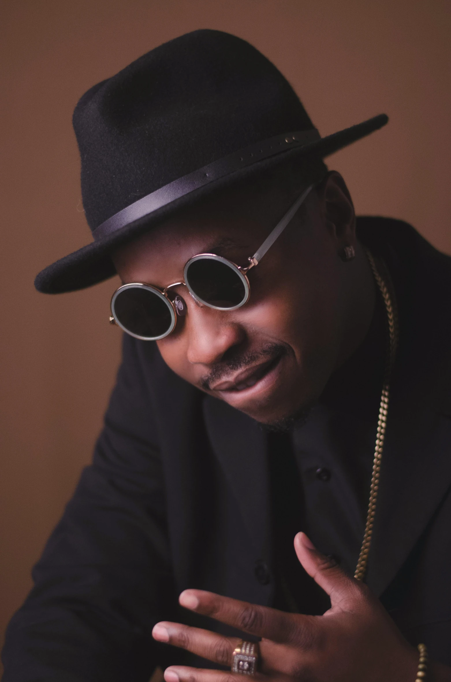 a close up of a person wearing a hat and sunglasses, an album cover, inspired by Zhu Da, trending on pexels, afrofuturism, doing an elegant pose over you, paul barson, confident looking, african jesse pinkman portrait