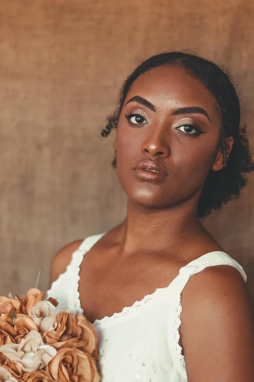 a woman in a wedding dress holding a bouquet, by Carey Morris, brown skin. light makeup, pose 1 of 1 6, modeled, large eyebrows