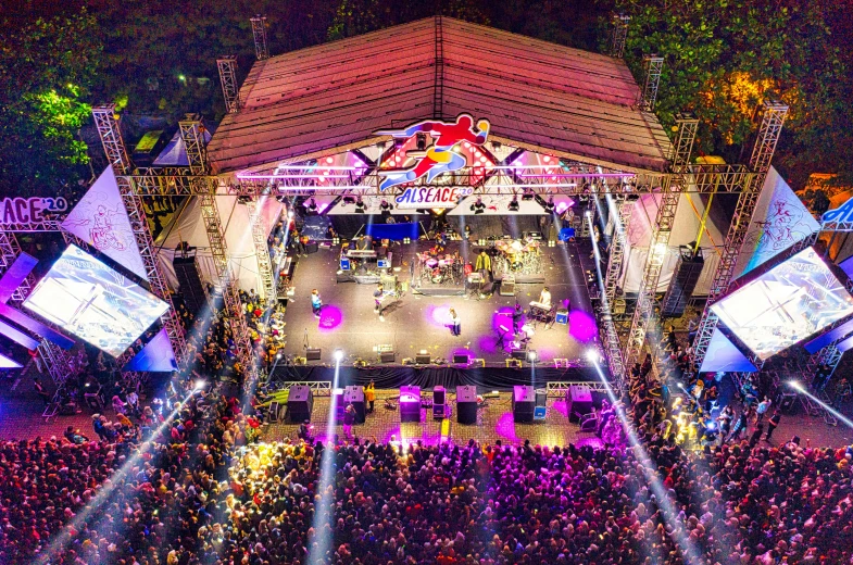 a group of people standing on top of a stage, bird's-eye view, red bull, carnaval de barranquilla, high lights