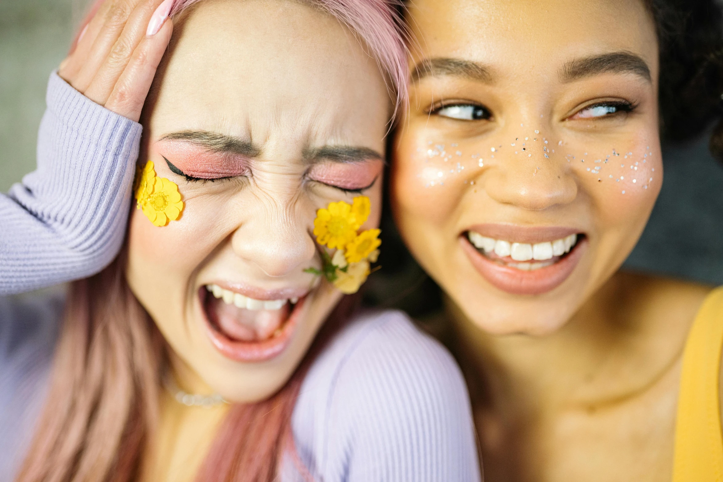 a close up of two women with flowers on their faces, trending on pexels, antipodeans, all overly excited, teenage girl, dewy skin, licking out