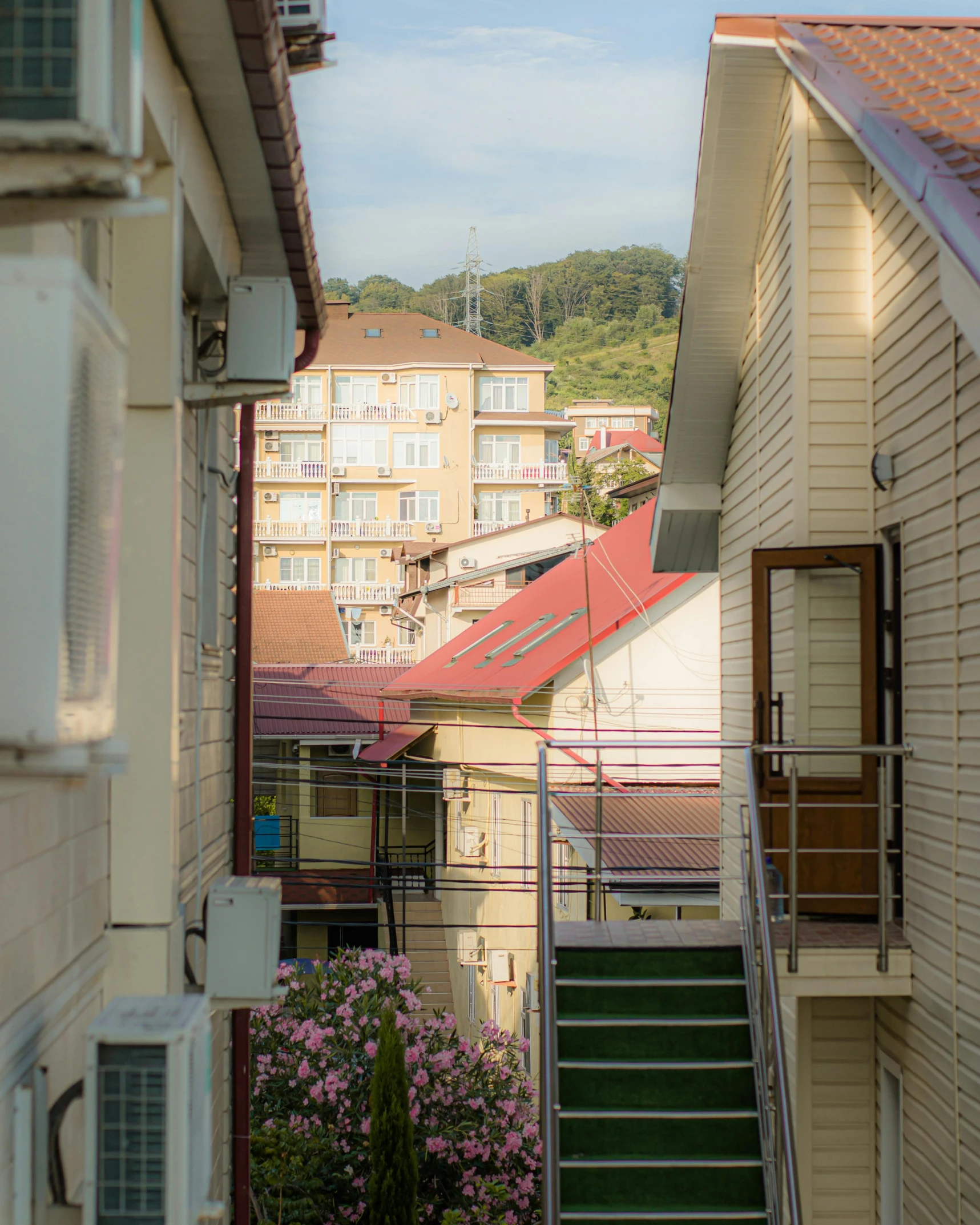 a couple of stairs going up the side of a building, by Elsa Bleda, unsplash, art nouveau, log houses built on hills, standing in township street, seaview, nikolay georgiev