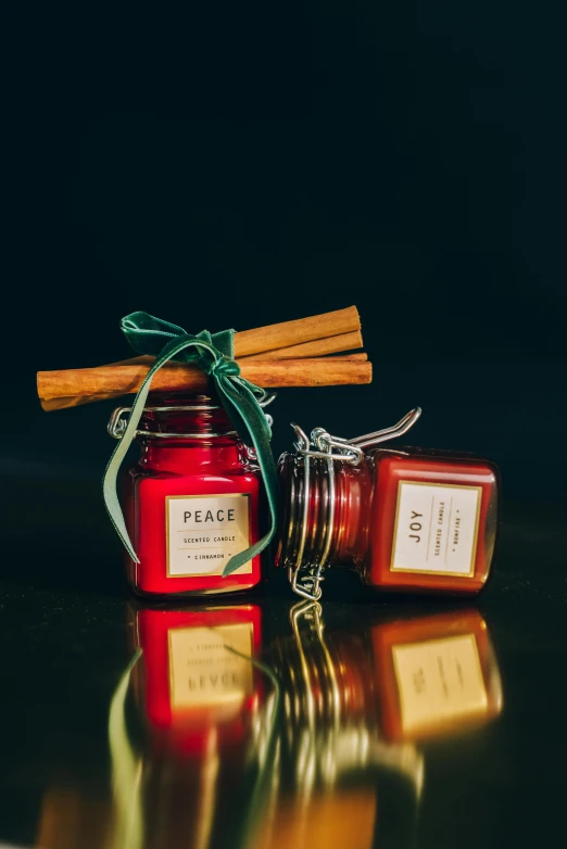 a couple of candles sitting on top of a table, viridian and venetian red, tiny sticks, cinnamon, full product shot