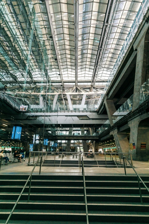 the inside of a building with a lot of stairs, unsplash, modernism, monorail station, in a massive cavernous iron city, finland, pritzker architecture prize