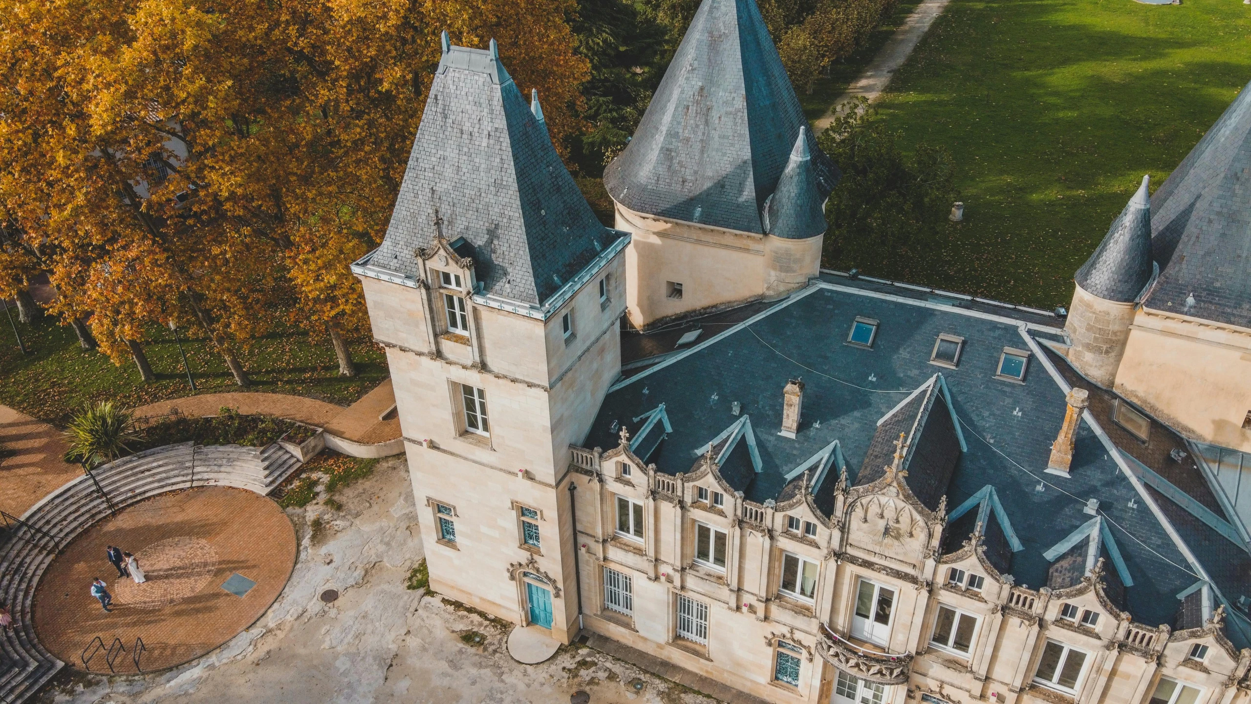 a large castle sitting on top of a lush green field, an album cover, by Raphaël Collin, pexels contest winner, drone view, pur champagne damery, during autumn, youtube thumbnail