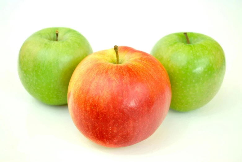 three apples sitting next to each other on a white surface, pexels, 15081959 21121991 01012000 4k, green bright red, medium head to shoulder shot, multi - coloured