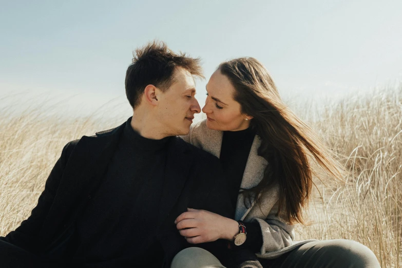 a man and woman sitting next to each other in a field, by Emma Andijewska, pexels contest winner, windy beach, avatar image, close up portrait photo, thumbnail