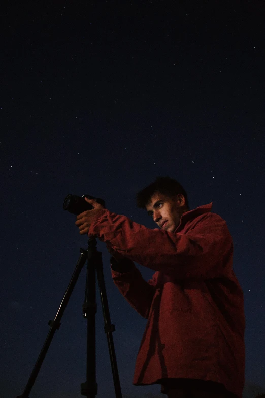 a man holding a camera on top of a tripod, by Daren Bader, pexels contest winner, night sky; 8k, headshot, diego fernandez, ilustration