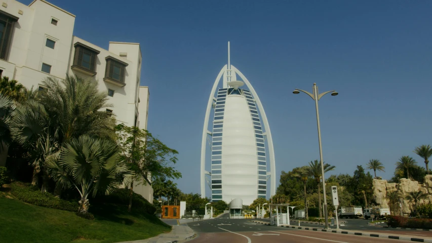 a tall building sitting on the side of a road, sheik mohammad ruler of dubai, hotel room, light house, exterior photo