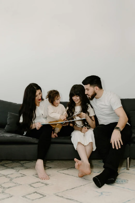 a family sitting on a couch reading a book, pexels contest winner, sleek design, low quality photo, profile image, avatar image