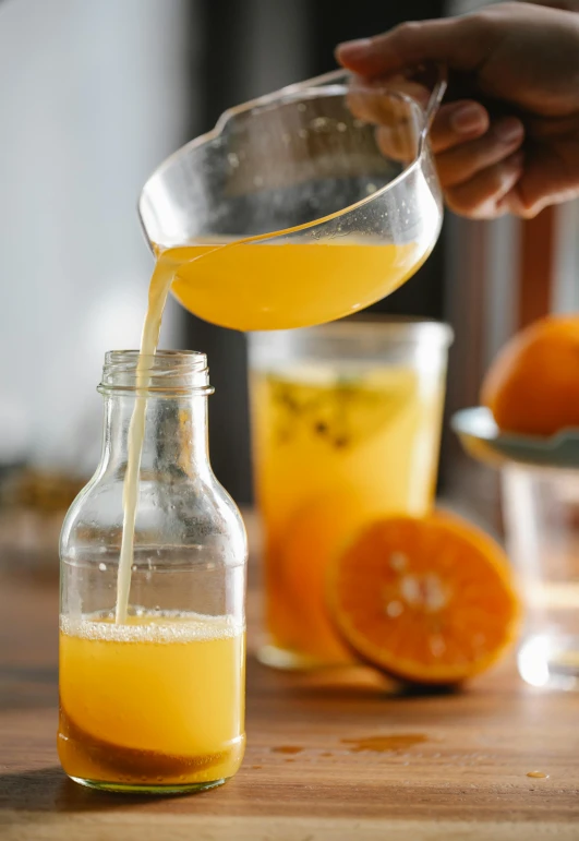 a person pouring orange juice into a glass, a picture, trending on pexels, renaissance, malaysian, thumbnail, made of drink, “organic