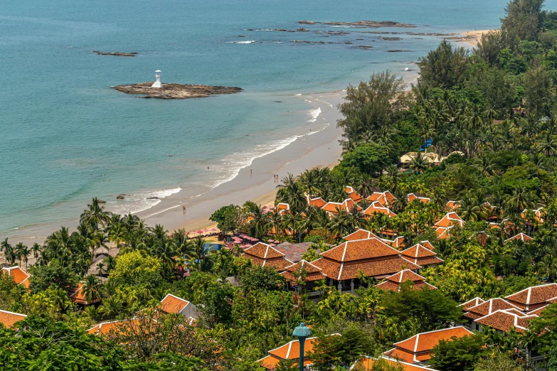 a view of a beach from the top of a hill, thai temple, white buildings with red roofs, lush surroundings, slide show