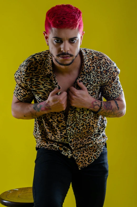 a man with red hair wearing a leopard print shirt, an album cover, inspired by Camilo Egas, trending on pexels, yellow walls, zigor samaniego style, dirty short sleeved shirt, close - up studio photo