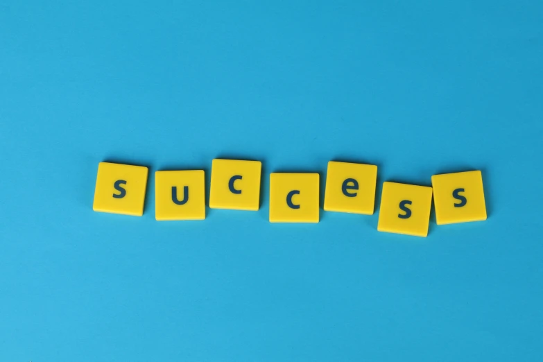 the word success spelled with scrabbles on a blue background, by Daniel Lieske, pexels, on a yellow canva, panels, taken from the high street, avatar image