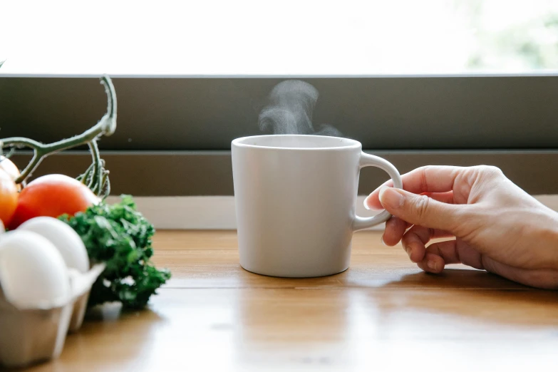 a person sitting at a table with a cup of coffee, sage smoke, misting, organic ceramic white, easy to use