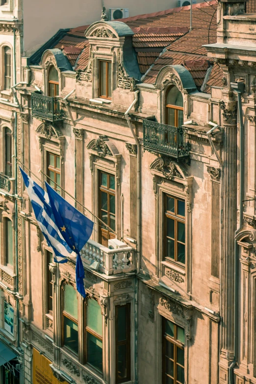 a large building with a flag flying in front of it, pexels contest winner, renaissance, greek nose, photograph from above, square, morning detail