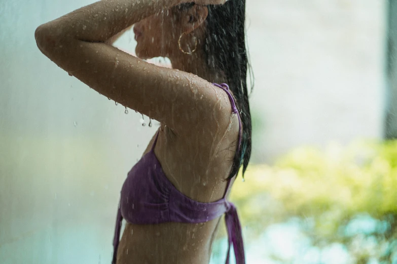 a woman in a purple bikini standing in the rain, pexels contest winner, side profile view, sunny day time, ad image, teenage girl