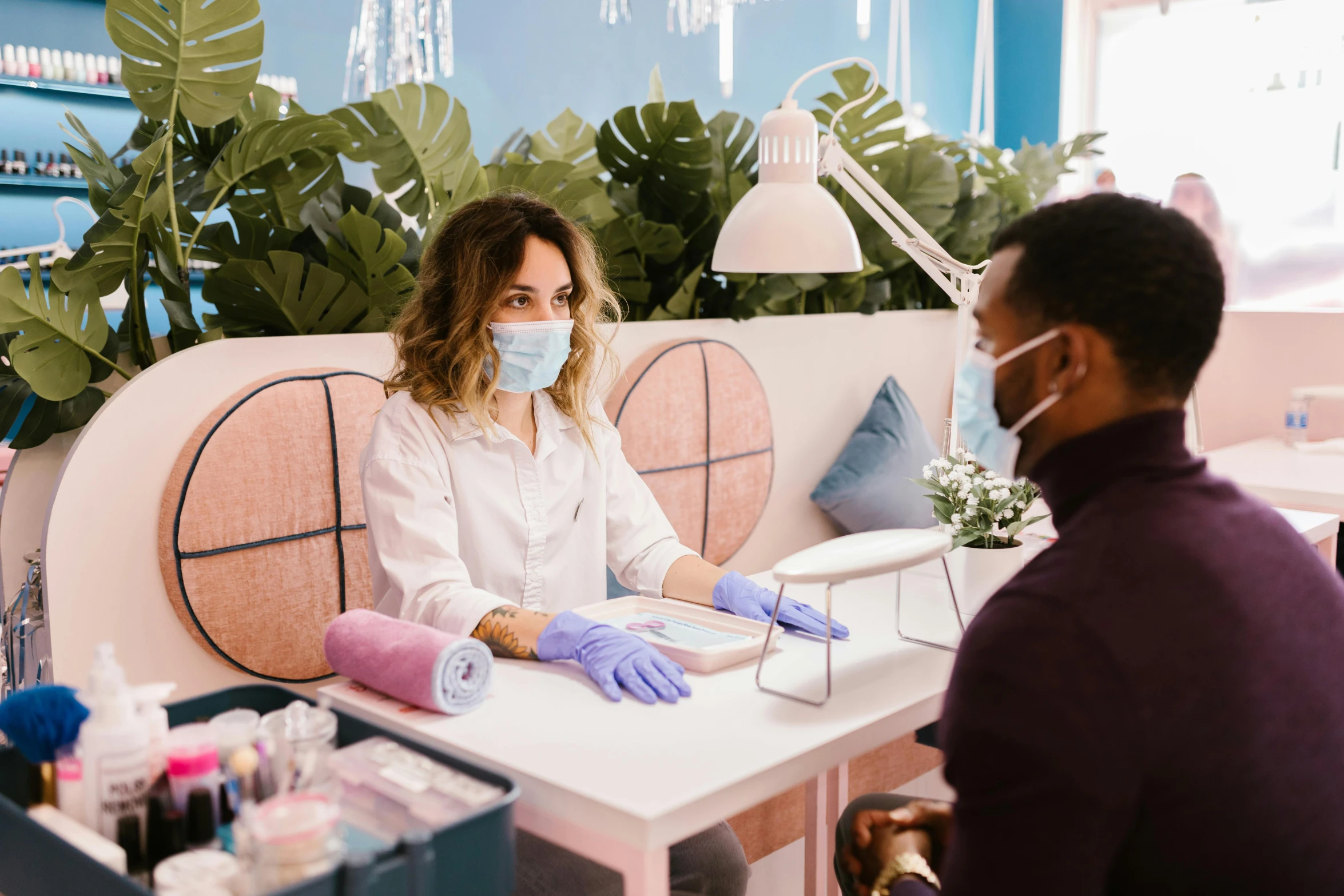 a woman sitting at a table with a mask on, pexels contest winner, candy treatments, wearing gloves, customers, josh black