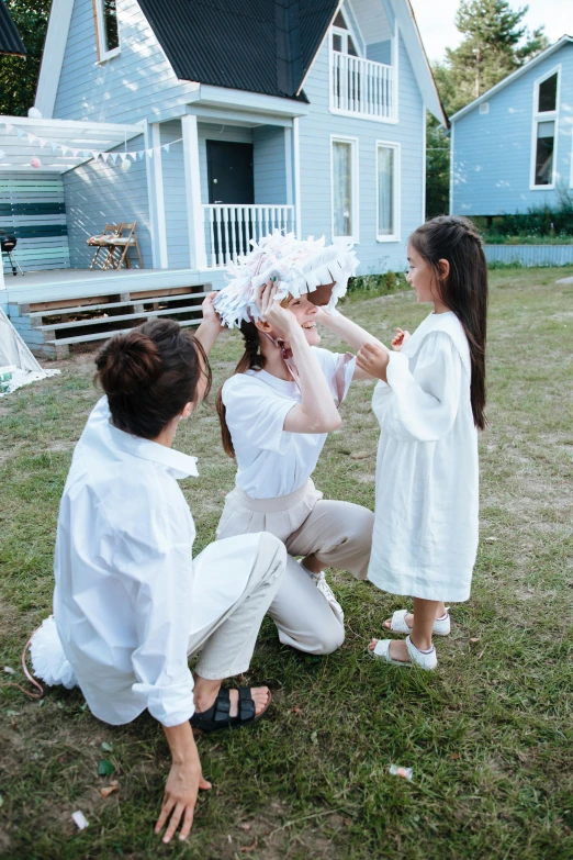 a group of people that are standing in the grass, white clothing, with a kid, ulzzang, at home